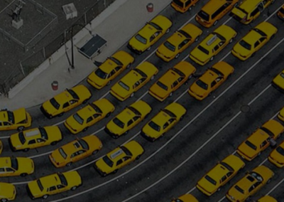 Street image of lots of yellow cabs filling six lanes of traffic