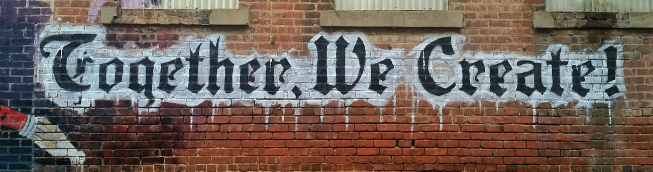 graffiti in gothic font reading 'together we create'