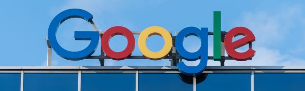 Google building sign in front of blue sky