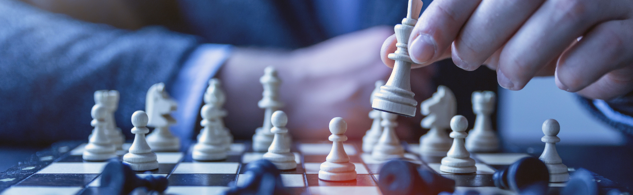 Close up of chessboard with man moving king piece